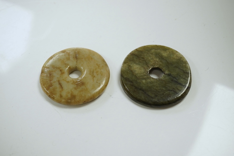 Two Chinese soapstone bi discs, and a jade ring, 18th century or earlier, largest 6.5cm in diameter. Condition - good